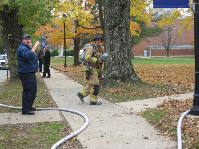 Career EMT Nick Sawyers and Lieutenant Win Slauch running electric into a building fire at Lincoln University.